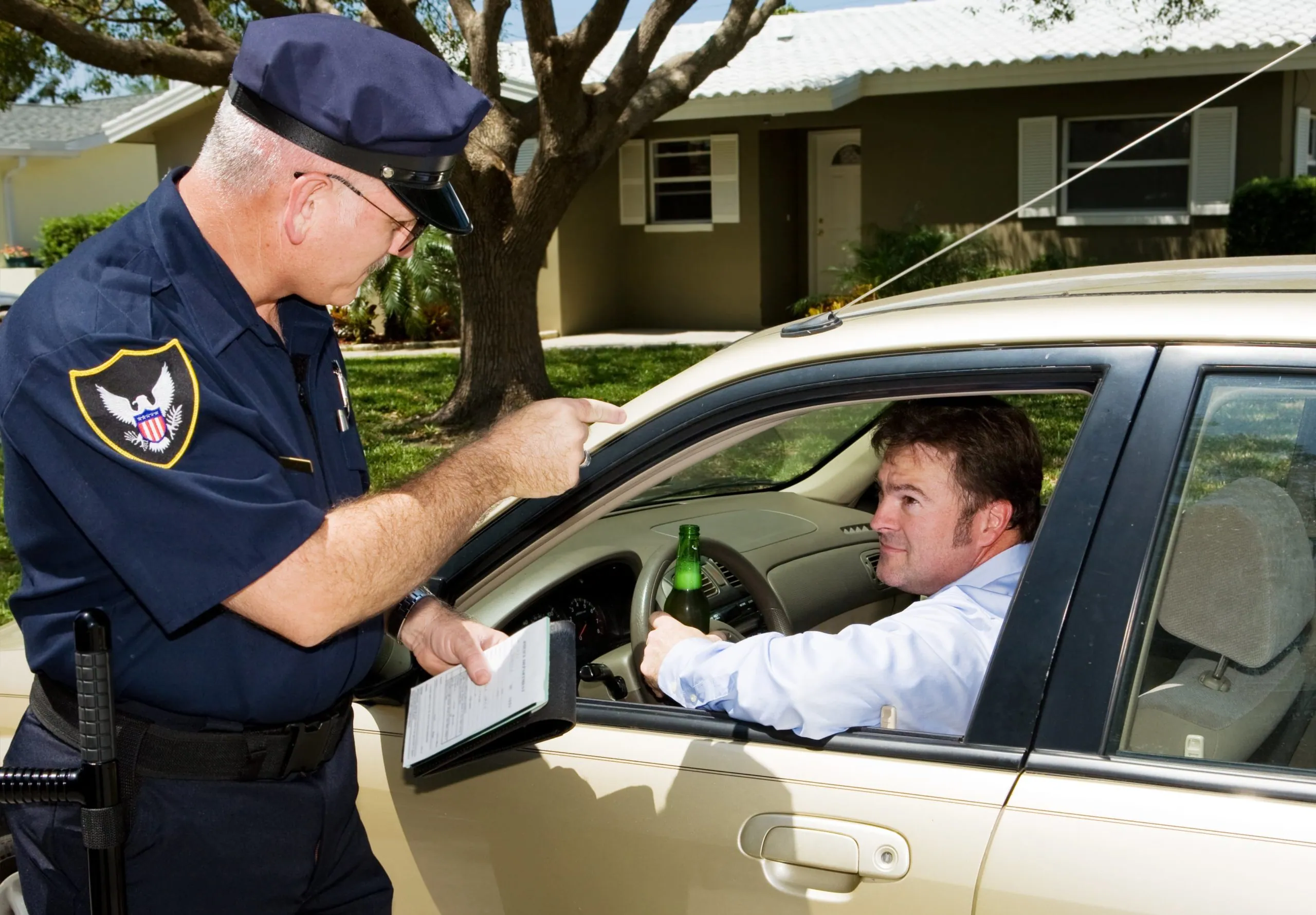 Police officer checking drunk driver.